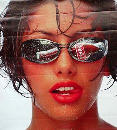 a woman with sunglasses and coca cola advertisement