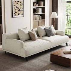 a living room filled with furniture and a book shelf next to a large open window