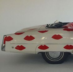 a white car with red lips painted on it