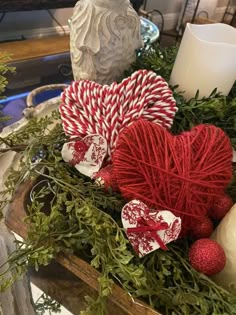 a basket filled with red and white candy canes, heart shaped lollipops