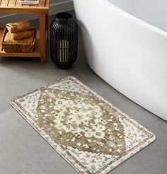 a bath tub sitting next to a rug on the floor