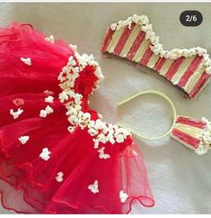 two pieces of red and white cake with popcorn on it next to a piece of candy