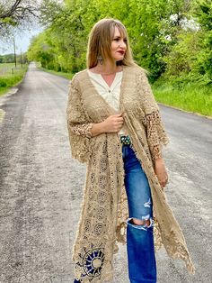 Embrace timeless fashion with The Dixieland Duster. This one-size crochet duster adds a statement piece to any outfit with its intricate details. Let your style shine with this must-have outerwear piece. model shown is a size 2/4, 5'6" tall and 34C bust fits sizes 2-18/20 very versatile in cut and fit 100% cotton Long Spring Festival Outerwear, One Size Open Front Open Knit Outerwear, Oversized Open Knit Bohemian Outerwear, Long Open Knit Outerwear For Summer, Beige Crochet Outerwear For Spring, Fitted Long Cardigan For Festivals, Bohemian Crochet Lace Cardigan For Fall, Fitted Bohemian Outerwear With Open Front, Bohemian Long Duster For Spring