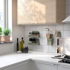 the kitchen counter is clean and ready to be used as a storage unit for cooking utensils