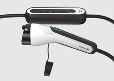 an electric hair dryer sitting on top of a black and white corded device