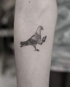 a bird with a piece of bread in it's beak on the left arm