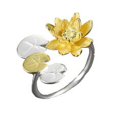 a gold and silver ring with a flower on the front, surrounded by three petals