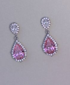 "Layla rose pink crystal earrings have the most beautiful sparkle due to the halo of tiny crystals surrounding both the earpost and the teardrop. We have used a clear crystal earpost which is also available as a clip on, to create a versatile and very pretty earring. Measurement: L-1\" (2.5cm) Set in non tarnish rhodium and are nickel, lead and cadmium free. 💙Clip on versions are available for this item. 💞 All our jewelry is presented in velvet pouches and high quality elegant, padded boxes re Pink Teardrop Jewelry With Halo Setting, Pink Teardrop Earrings For Formal Occasions, Pink Pear-shaped Earrings For Anniversary, Sparkling Pink Cubic Zirconia Earrings, Pink Sparkling Cubic Zirconia Earrings, Pink Party Jewelry With Halo Setting, Pink Teardrop Cubic Zirconia Jewelry, Pink Jewelry With Halo Setting For Party, Pink Cubic Zirconia Teardrop Jewelry