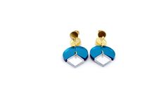 Elevate your style with these teal dangle earrings – a striking fusion of modern design and vibrant color that will set you apart from the crowd. These earrings are a perfect accessory for those who appreciate contemporary fashion and crave a touch of geometric elegance. They feature teal, gold, and silver mirror acrylic laser cut into geometric shapes. Each earring is completed with a stainless steel ear post. MATERIALS Acrylic Charms Stainless Steel Ear Posts LENGTH 2" CARE Direct contact with Acrylic Charms, Silver Mirrors, Contemporary Fashion, Geometric Shapes, Modern Design, Dangle Earrings, Vibrant Colors, Silver, Gold