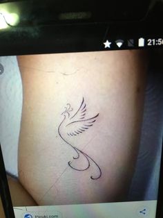 a person's leg with a bird tattoo on the left side of their thigh