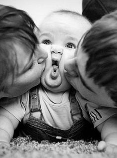 two adults and a baby making faces with their mouths open