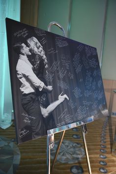 a couple kissing on the cheek in front of a black and white photo with writing all over it