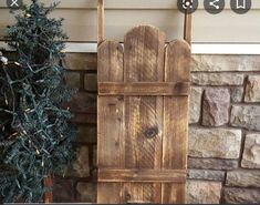 a small wooden chair next to a christmas tree and sign that says wood's creek