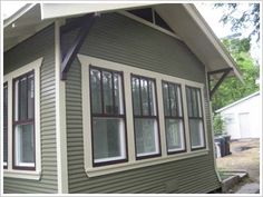 a green house with white trim and windows