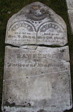 two stone slabs with carvings on them sitting in the grass