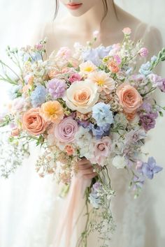 a woman holding a bouquet of flowers in her hands