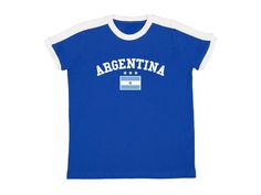 Argentina Baby Tee Blue ringer t shirt with white contrast collar, arched Argentina graphic, Argentinian flag and stars. Blokette and soccer inspired jersey shirt. #sporty #coquette #blokecore #handmade #summer Available in sizes small, medium, and large Measurements (in inches): Small- Width: 16 Length: 21.5 Medium- Width: 18 Length: 23 Large- Width: 19 Length: 25 Care Instructions: * Do not dry clean * Wash and dry inside out * Hang dry (preferred) or machine dry on a delicate setting * Use co Sporty Cotton T-shirt With Flag Print, Sports T-shirt With Flag Print In Cotton, Sports T-shirt With Flag Print, Team Spirit Short Sleeve Tops With Three Stripes, Flag Print Crew Neck Tops For Sports Events, Sporty Coquette, Argentina Shirt, Argentinian Flag, Argentina Flag