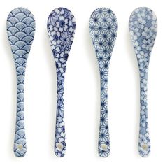 four blue and white spoons with designs on them