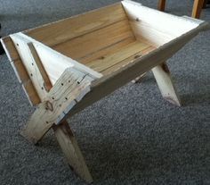 a wooden table that has been made out of pallets and is sitting on the floor