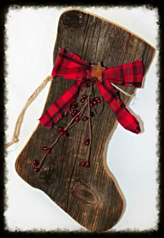 an image of a christmas stocking made out of wood with red and white plaid ribbon