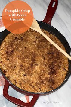 pumpkin crisp with pecan crumble in a cast iron skillet on a checkered tablecloth