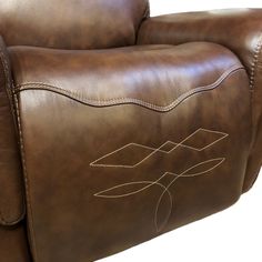 a brown leather recliner with stitching on it