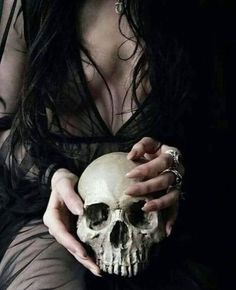 a woman holding a skull in her hands