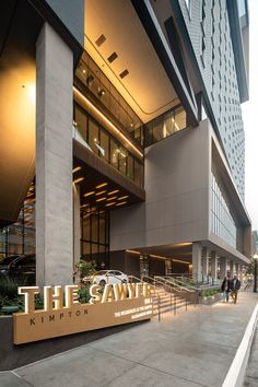 the entrance to an office building with people walking by