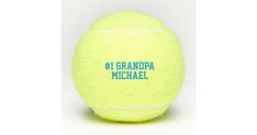 a yellow tennis ball with the words grandpaa michael on it's back side