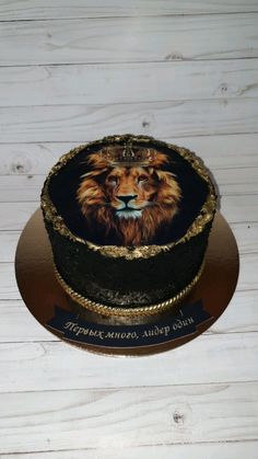 a cake with a lion on it sitting on top of a white wooden table next to a wall