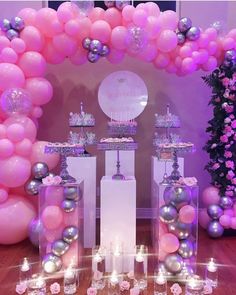 a table topped with lots of balloons and candles