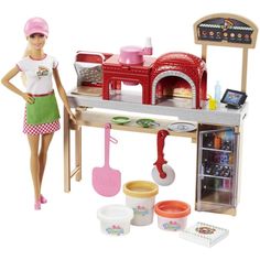 a barbie doll is standing next to a kitchen set with cooking utensils and accessories