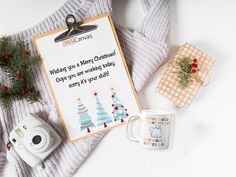 a christmas card with a camera, coffee mug and other items on top of it