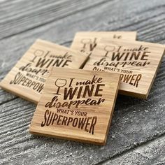 three coasters with wine sayings on them sitting on a wooden surface, one is made out of wood and the other has black lettering