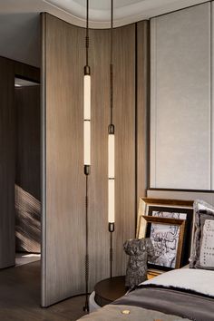 a bed room with a neatly made bed next to a tall wooden wall mounted light