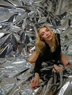 a woman sitting on top of tin foil