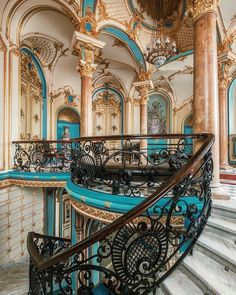 an ornate staircase with blue and gold paint