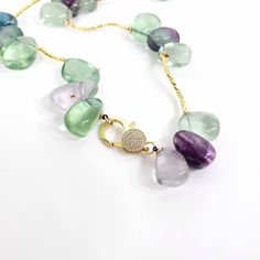 Admire the beauty of our Elegant Rainbow Fluorite Crystal Necklace, a stunning piece of jewelry that looks beautiful and carries powerful healing properties. Crafted with high-quality, natural Rainbow Fluorite crystals, this gemstone necklace is renowned for balancing and uplifting energy, providing a sense of calm and harmony.This crystal necklace features beautiful, colorful Rainbow Fluorite Crystal Beads, each measuring about 14x20mm. Beyond its aesthetic appeal, Rainbow Fluorite is known for Fluorite Jewelry, Fluorite Crystals, Fluorite Necklace, Gemstone Choker, Crystal Fashion, Fluorite Crystal, Emotional Balance, Rainbow Fluorite, Natural Rainbow