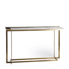 a brass and glass console table with an open shelf on one side, against a white background