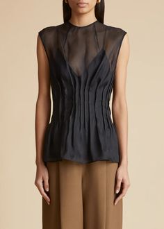 The Westin Top in Black– KHAITE Sleeveless Organza Tops For Spring, Elegant Sleeveless Organza Blouse, Chic Sleeveless Top With Bust Darts, Elegant Sleeveless Organza Top, Fitted Sleeveless Organza Blouse, Elegant Sleeveless Sheer Blouse, Sleeveless Organza Party Tops, Fitted Sleeveless Top With Sheer Bodice, Fitted Silk Chiffon Formal Top