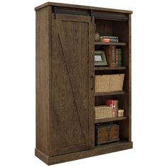 an armoire with baskets and books in it