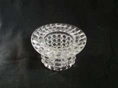 a clear glass bowl sitting on top of a black table