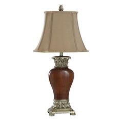 a table lamp with a brown shade on it's base and a white background