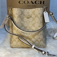 Printed Coated Canvas And Smooth Leather Center Zip Compartment Snap Closure Detachable Handle With 6 3/4" Drop Detachable Strap With 22" Drop For Shoulder Or Crossbody Wear 8" (L) X 8 1/2" (H) X 4" (W) Style No. Cf422 Designer Cream Bucket Bag With Detachable Handle, Designer Cream Bucket Bag With Gold-tone Hardware, Designer White Bucket Shoulder Bag, Luxury White Crossbody Bucket Bag, Luxury White Bucket Bag With Detachable Strap, Designer White Bucket Bag With Detachable Strap, White Crossbody Bucket Bag With Gold-tone Hardware, Luxury White Bucket Bag With Removable Pouch, Formal White Rectangular Bucket Bag