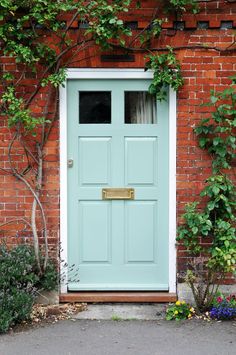 a blue front door on a brick building