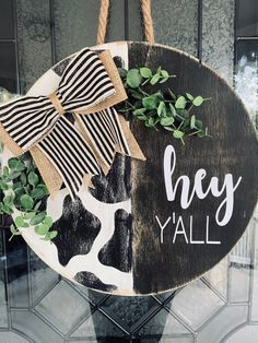 a black and white sign that says hey y'all with a bow on it