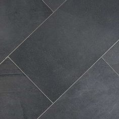 a black tile floor with grey grouting