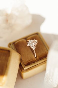 an engagement ring sitting on top of a box