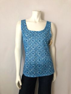 "Vintage Women's 70's NOS, Blue, Floral, Tank Top by White Stag (L) This Ladies tank top comes in a blue polyester/silk blend with a floral desig, has a scoop neckline, and is sleeveless. The fabric is light weight with two way stretch. 95% Polyester 5% Silk Made in USA *This tank top is unworn without the original tag. Size: (L) Modern Day 8/10 (Tag Size: L) Bust: 38\" Length: 25 1/2\" Shoulder to Shoulder: open Weight: 5 oz *Follow FreshandSwanky on Instagram *Follow freshandswanky.blogspot.co Blue Printed Sleeveless Top, Blue Stretch Cotton Blouse, Stretch Cotton Blue Blouse, Blue Floral Print Sleeveless Top, Blue Sleeveless Floral Print Top, Spring Blue Printed Tops, Fitted Blue Printed Tops, Fitted Blue Printed Blouse, Blue Printed Tops For Spring