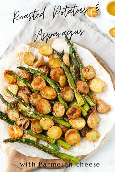 roasted potatoes and asparagus with parmesan cheese on a white platter